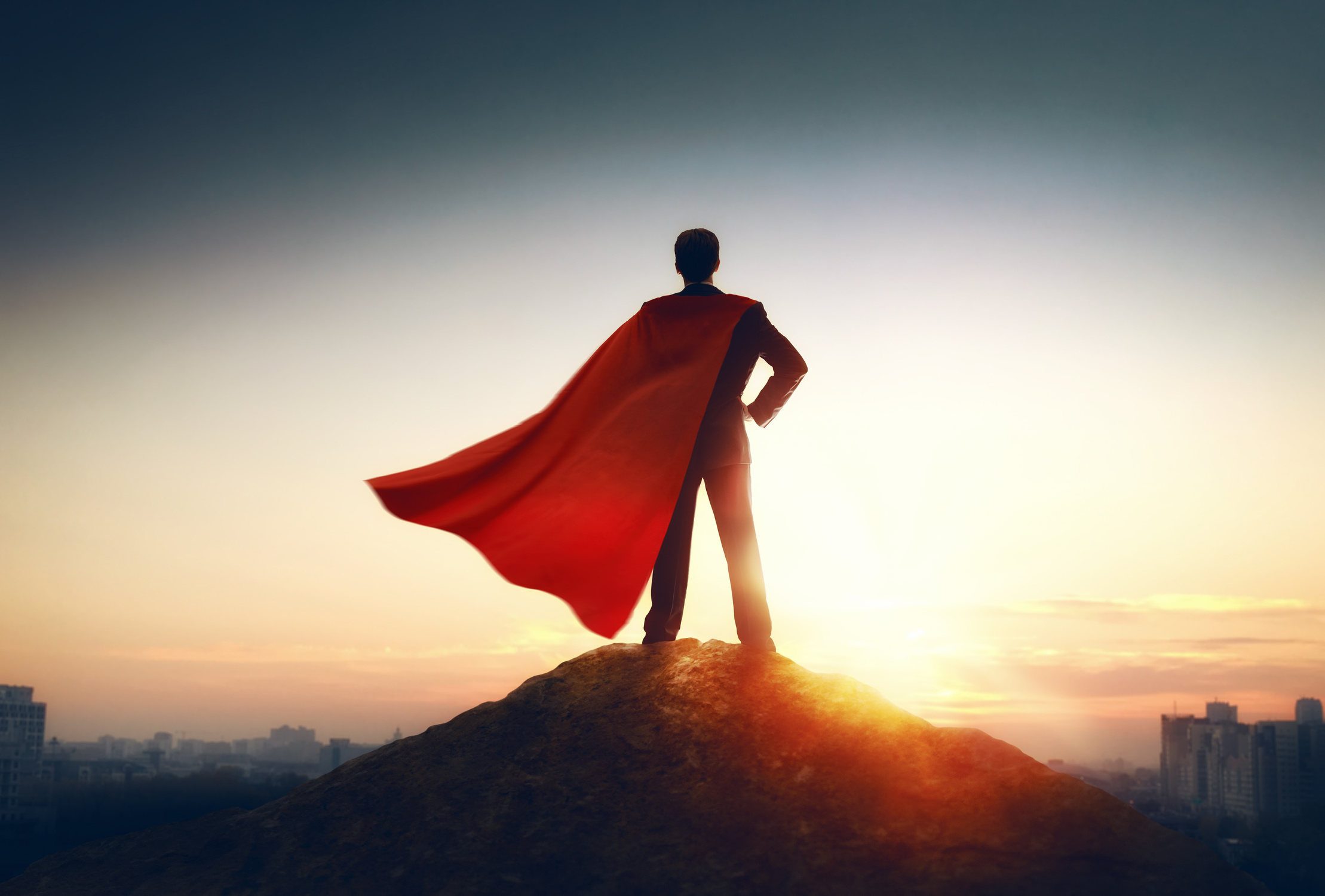 superhero businessman looking at city